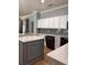 Kitchen with white upper cabinets and a gray island and featuring black appliances at 8298 Sw 79Th Cir, Ocala, FL 34476
