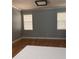 Well-lit living room boasts hardwood floors, baseboard trim, and a ceiling fan at 8298 Sw 79Th Cir, Ocala, FL 34476