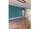 Spacious living room featuring wood floors, recessed lighting, and a accent colored wall at 8298 Sw 79Th Cir, Ocala, FL 34476