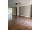 Spacious living room featuring wood flooring and a sliding glass door at 8298 Sw 79Th Cir, Ocala, FL 34476