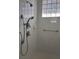 Tiled shower with modern shower head, controls, and glass block window for natural light at 8298 Sw 79Th Cir, Ocala, FL 34476