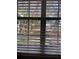 Exterior view through the bedroom window showing trees, vegetation, and natural sunlight at 8298 Sw 79Th Cir, Ocala, FL 34476