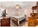 Cozy bedroom featuring a queen-size bed, area rug, ceiling fan and closet at 8732 Sw 60Th Cir, Ocala, FL 34476