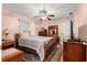 Cozy bedroom featuring a queen-size bed, area rug, ceiling fan and closet at 8732 Sw 60Th Cir, Ocala, FL 34476