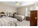 Bright bedroom featuring two twin beds with coordinated bedding, ceiling fan and closet at 8732 Sw 60Th Cir, Ocala, FL 34476