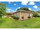 A well-maintained home features manicured landscaping with rocks, bushes, and a green lawn at 8732 Sw 60Th Cir, Ocala, FL 34476