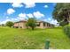Picture of home's exterior showcasing the well-maintained lawn, screened lanai, and mature shrubs at 8732 Sw 60Th Cir, Ocala, FL 34476