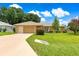 Charming single-story home featuring a well-manicured lawn and a two-car garage at 8732 Sw 60Th Cir, Ocala, FL 34476