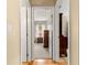 Hallway view showing bedrooms, wood floor and doors at 8732 Sw 60Th Cir, Ocala, FL 34476