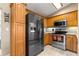 Well-equipped kitchen features stainless steel appliances and wooden cabinetry at 8732 Sw 60Th Cir, Ocala, FL 34476