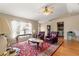 Bright living room with hardwood floors, windows, and classic furniture that provides a cozy feel at 8732 Sw 60Th Cir, Ocala, FL 34476