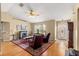 Cozy living room with fireplace, ceiling fan, and comfortable leather armchairs at 8732 Sw 60Th Cir, Ocala, FL 34476