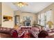 Living room with a stone fireplace, plush leather furniture, and decorative rugs at 8732 Sw 60Th Cir, Ocala, FL 34476