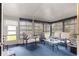 Bright sunroom with large windows, neutral furnishings, and comfortable seating at 8732 Sw 60Th Cir, Ocala, FL 34476