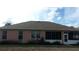 Rear exterior of home shows a screened-in porch, windows, and a well-kept backyard at 8781 Sw 82Nd Court Rd, Ocala, FL 34481