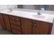 Bathroom featuring a double vanity sink with a white countertop and wooden cabinets at 8781 Sw 82Nd Court Rd, Ocala, FL 34481
