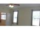 Bedroom with neutral walls, ceiling fan, and two windows for natural light at 8781 Sw 82Nd Court Rd, Ocala, FL 34481