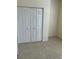 Bright bedroom featuring a spacious closet and neutral tile flooring at 8781 Sw 82Nd Court Rd, Ocala, FL 34481
