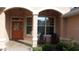 Covered entryway featuring a decorative front door, large windows, and chairs for a relaxing welcome at 8781 Sw 82Nd Court Rd, Ocala, FL 34481