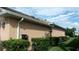 Exterior view of a peach home with a well maintained green lawn and clean white gutters at 8781 Sw 82Nd Court Rd, Ocala, FL 34481
