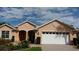 Charming single-story home with brick driveway, manicured landscaping, and an attached two-car garage at 8781 Sw 82Nd Court Rd, Ocala, FL 34481