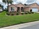 Beautiful single-story home with lush lawn, mature trees, and manicured landscaping at 8781 Sw 82Nd Court Rd, Ocala, FL 34481