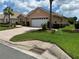 Inviting single-story home with manicured lawn, and a brick-paved driveway leading to a two-car garage at 8781 Sw 82Nd Court Rd, Ocala, FL 34481