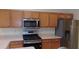 Kitchen featuring wooden cabinets, stainless steel appliances, and a breakfast bar at 8781 Sw 82Nd Court Rd, Ocala, FL 34481