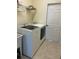 Laundry room featuring modern washer and dryer, a utility sink, and white door at 8781 Sw 82Nd Court Rd, Ocala, FL 34481