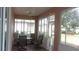 Enclosed patio with seating area, ceiling fan, and views of backyard at 8781 Sw 82Nd Court Rd, Ocala, FL 34481