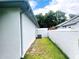 Side yard showing privacy wall and lush green landscape at 9328 Sw 192Nd Court Rd, Dunnellon, FL 34432