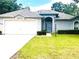 Charming single-story home featuring an attached garage, manicured lawn, and inviting front entrance at 9328 Sw 192Nd Court Rd, Dunnellon, FL 34432