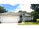 Charming single-story home featuring an attached garage, manicured lawn, and inviting front entrance at 9328 Sw 192Nd Court Rd, Dunnellon, FL 34432