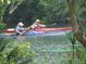 People enjoy kayaking on a waterway surrounded by lush vegetation at 9328 Sw 192Nd Court Rd, Dunnellon, FL 34432