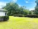 Expansive yard with neatly trimmed hedges, offering privacy and enhancing the property's curb appeal at 9328 Sw 192Nd Court Rd, Dunnellon, FL 34432