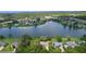 Panoramic aerial view showcasing the tranquil lake, lush greenery, and the surrounding residential community at 95 Hickory Loop, Ocala, FL 34472