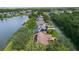 Scenic aerial view of lakeside homes with pools, solar panels, and manicured lawns at 95 Hickory Loop, Ocala, FL 34472