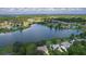 Breathtaking aerial view of a tranquil lake surrounded by residential homes and lush greenery at 95 Hickory Loop, Ocala, FL 34472