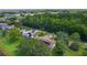 Overhead view of a residential area surrounded by lush trees and well-maintained lawns at 95 Hickory Loop, Ocala, FL 34472