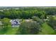Aerial shot of homes with screened pools and solar panels surrounded by verdant greenery at 95 Hickory Loop, Ocala, FL 34472