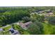 Aerial perspective showcases a home with solar panels, lush landscaping, and a serene neighborhood at 95 Hickory Loop, Ocala, FL 34472