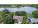 Aerial view of a waterfront property with a private pool, lush landscaping, and stunning lake views at 95 Hickory Loop, Ocala, FL 34472