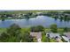 Aerial shot of a beautiful waterfront house with mature trees, a pool, and serene lake views at 95 Hickory Loop, Ocala, FL 34472