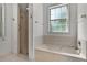 Bathroom with shower, tub, white marble countertops, and patterned wallpaper border at 95 Hickory Loop, Ocala, FL 34472
