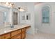Bright bathroom with tiled floors, spacious vanity, and decorative wallpaper border at 95 Hickory Loop, Ocala, FL 34472