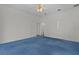 Large bedroom features blue carpet, white walls and ceilings, and ample closet space at 95 Hickory Loop, Ocala, FL 34472