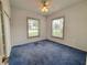 Carpeted bedroom with twin windows and closet. Wallpaper accents add charm at 95 Hickory Loop, Ocala, FL 34472