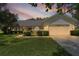 Charming single-story home features a well-manicured lawn and two-car garage at 95 Hickory Loop, Ocala, FL 34472