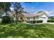 Charming single-story home with a well-manicured lawn, mature landscaping, and a two-car garage at 95 Hickory Loop, Ocala, FL 34472