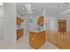 A kitchen with wooden cabinets and white appliances flows into an open-concept living space at 95 Hickory Loop, Ocala, FL 34472